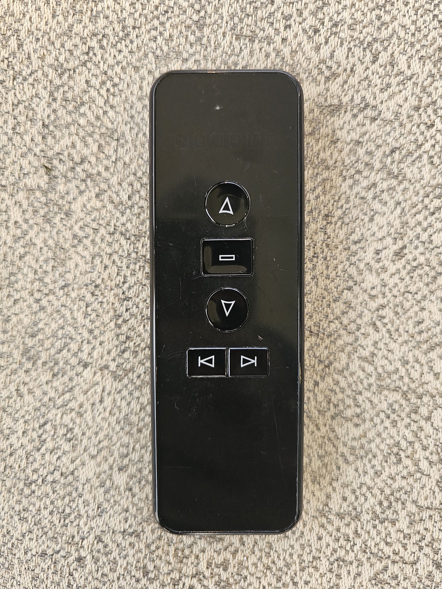 Handheld remote for motorized patio screens.